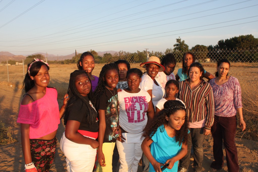  Brandi Mack (center, in hat) directs a girl's program at Hunters Point