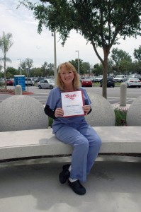 Arrowhead Regional Medical Center (ARMC) registered nurse Cheryl Meis, holds her Woman of Distinction award, which was presented to Meis at the 2014 Women of Distinction Awards Ceremony held recently at the National Orange Show in San Bernardino. The annual event recognizes women from throughout the region who demonstrate a strong commitment to their communities.