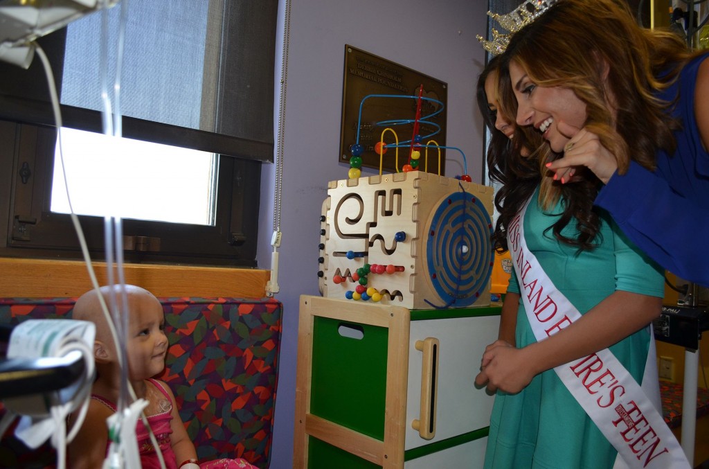 2014 Miss Inland Empire Rita Garabet, 21, of Redlands (right) and Miss Inland Empire Outstanding Teen Sophia Torres, 14, of Apple Valley, visit with Aubrey Olivas, 2, of Rancho Cucamonga, during the title holders’ stop at Loma Linda University Children’s Hospital on Wednesday, Sept. 10.