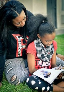 T'ana and daughter reading Bratty Tatty