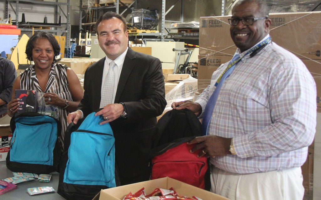 County Schools' Deputy Superintendent Ted Alejandre (left) puts supplies in backpacks, along with County Schools' Homeless Education specialist Brenda Dowdy (left) and Earl Smith, coordinator of Child, Welfare and Attendance for County Schools.