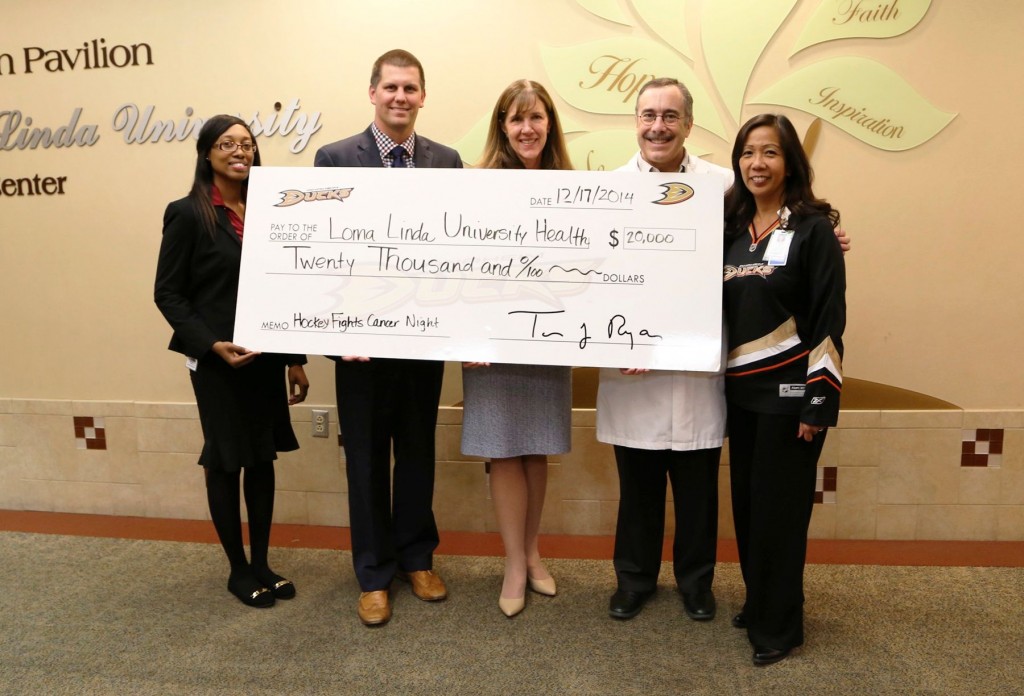 The Anaheim Ducks Donate $20,000 to Loma Linda University Health to Support Cancer Services.  Pictured (L to R) from the Anaheim Ducks organization are Christian Young, Corporate Partnership Activation Coordinator, and Graham Siderius, Corporate Partnership Director.  Joining them from the Loma Linda University Cancer Center are Judy Chatigny, Executive Director; Dr. Mark Reeves, Medical Director; and Lexine Thall, Director of Patient Care. 