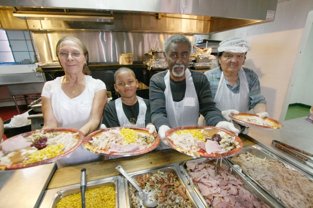 Volunteers serve Thanksgiving Dinner at The Salvation Army: Serving on the food line (left to right) is Nancy Veaegas, Niyahn Summey, Walt Summey, and Robert Sanchez. We are ready for Christmas Dinners.   (Photo by Ricardo Tomboc)