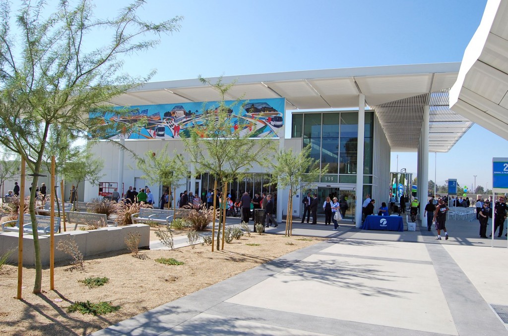 The San Bernardino Transit Center is a LEED Gold designed facility which includes drought tolerant landscaping and public art. The mural banner, “Exploration” by Louie Solano, hangs from the north side of the building.