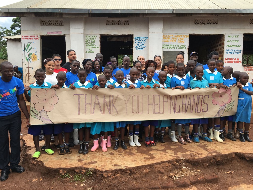 Students at New Generation Nursery and Primary School are all smiles after receiving shoes and school supplies donated from Helping Hands and the 1 Uganda Project. 