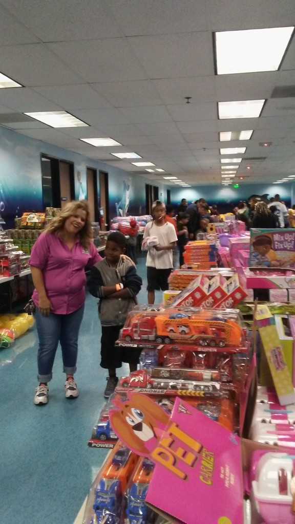 The Way World Outreach held its 12th annual Christmas present giveaway at its Hallmark campus on Sunday evening, where over 2,000 youth received a gift of their choosing.  Pictured is The Way World Outreach Children’s Pastor Susan Zavala with Jovonn Taylor, 9. (Photo credit MJ Duncan)