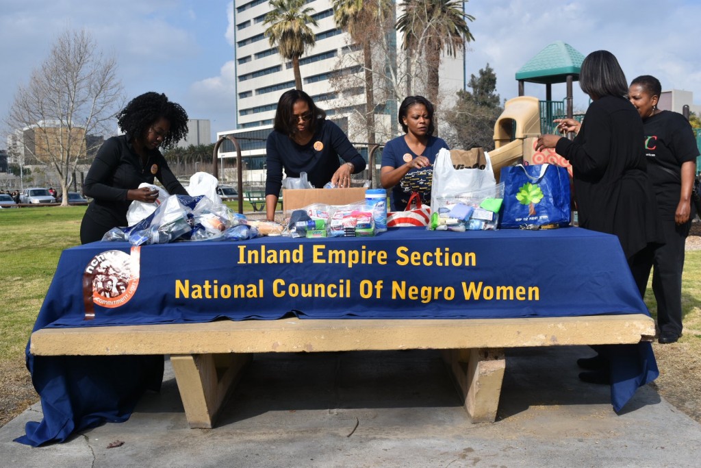 Members of NCNW prepare table a Meadowbrook Park to deliver care packets to the homeless. 