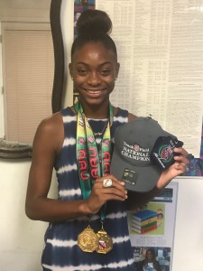 Jordyn Grady displaying her medals and ring that she won in the AAU Junior National Olympics. (Photo Credit: Naomi K. Bonman)